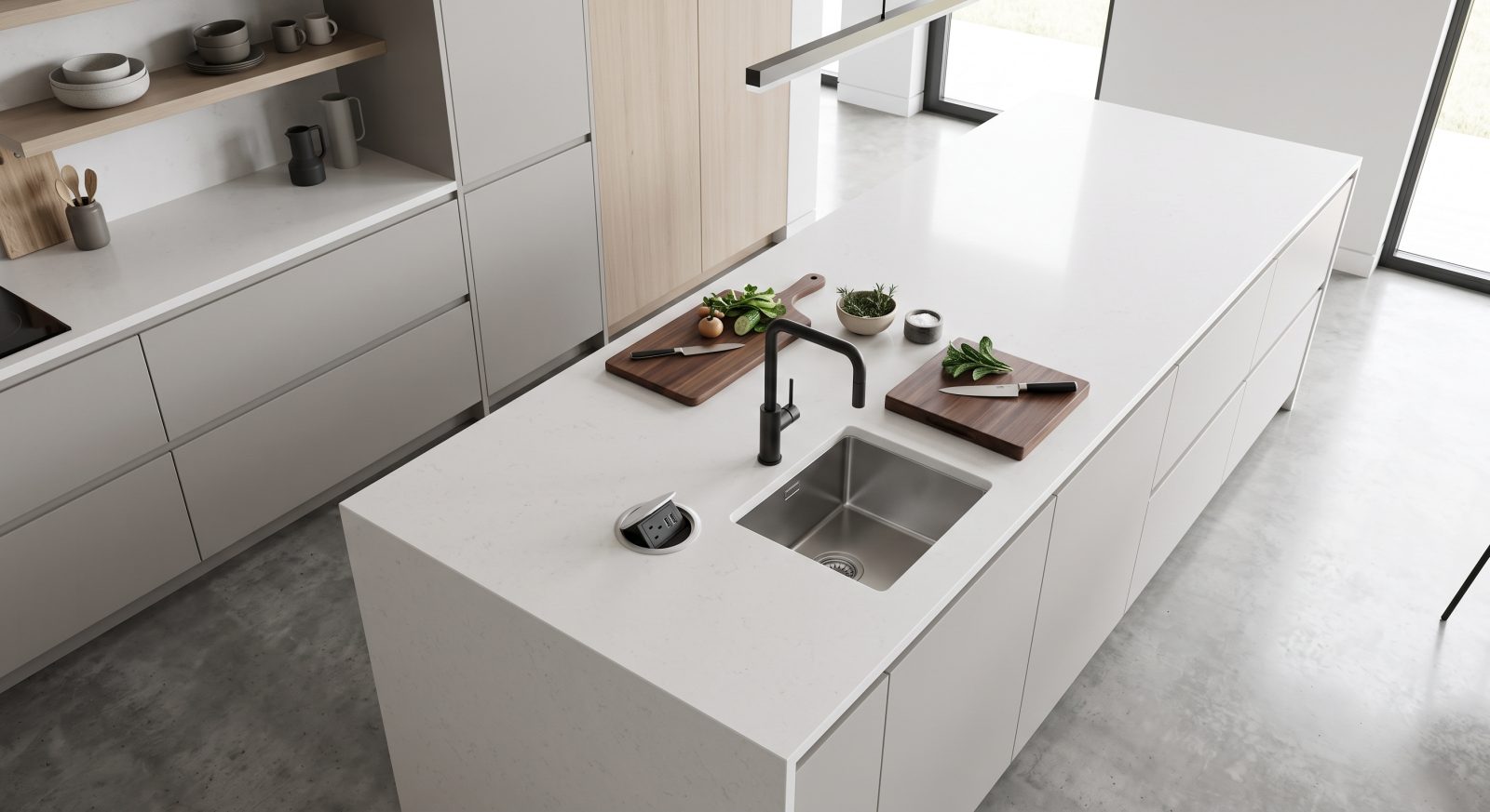 Overhead view of a kitchen island with a built-in countertop outlet near a prep sink, modern kitchen design photography